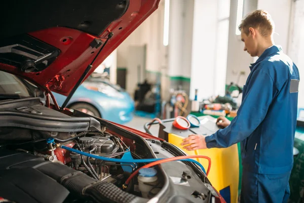 Car in a workshop bay during an air conditioning service